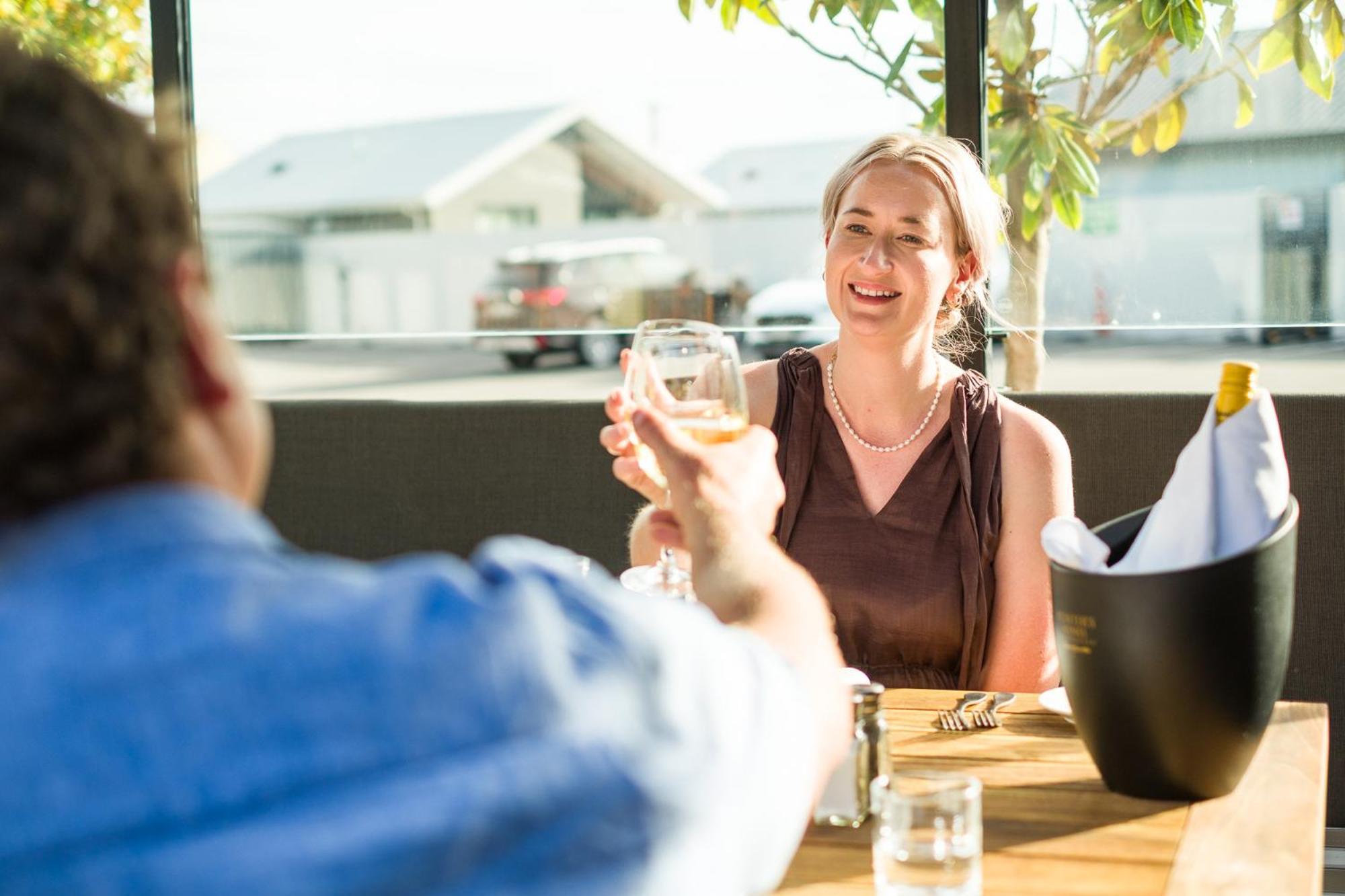 Carnmore Chateau Marlborough Blenheim Buitenkant foto A woman toasting with a glass of wine